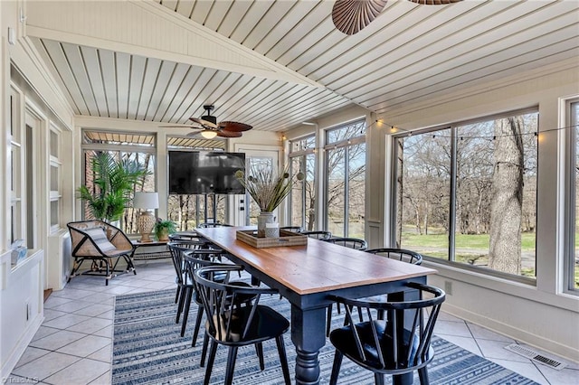 sunroom / solarium featuring ceiling fan