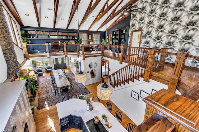 living room featuring lofted ceiling with beams and light wood-type flooring
