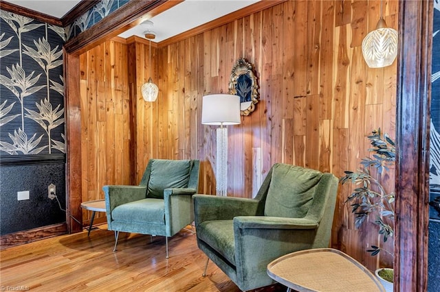 sitting room featuring hardwood / wood-style flooring and ornamental molding