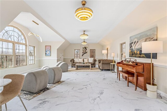 living area featuring plenty of natural light and vaulted ceiling