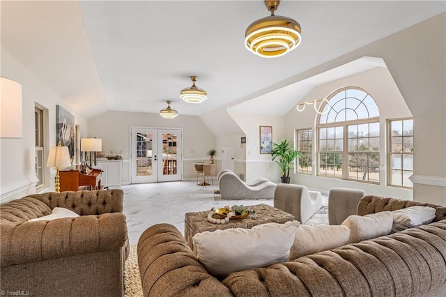 living room with vaulted ceiling and french doors