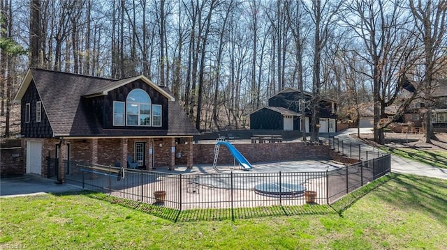 view of pool featuring a yard, a water slide, and a patio area