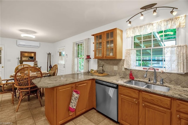 206 Westwood Dr, Kernersville, NC 27284 - kitchen with a sink, a peninsula, an AC wall unit, decorative backsplash, and stainless steel dishwasher