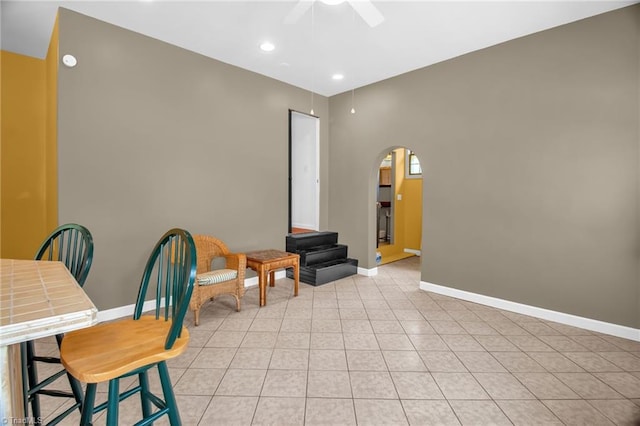 206 Westwood Dr, Kernersville, NC 27284 - sitting room featuring light tile patterned flooring, arched walkways, a ceiling fan, and baseboards