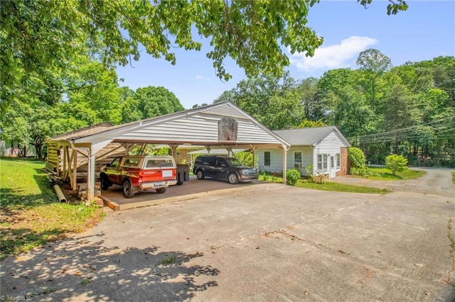 206 Westwood Dr, Kernersville, NC 27284 - view of vehicle parking with concrete driveway and a carport