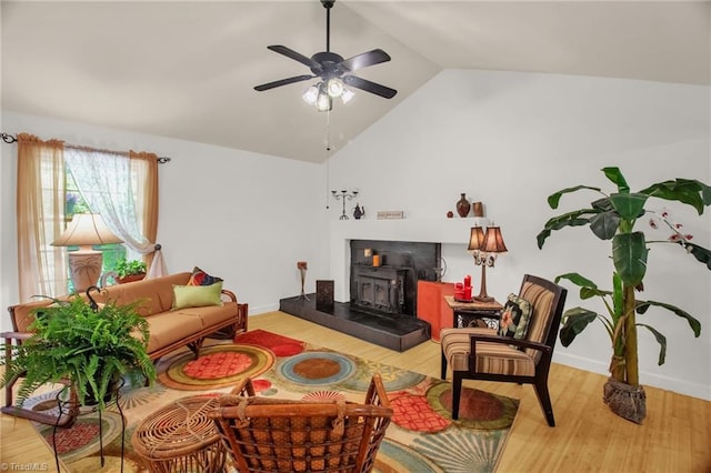 206 Westwood Dr, Kernersville, NC 27284 - living room featuring light wood-style flooring, high vaulted ceiling, baseboards, ceiling fan, and a wood stove