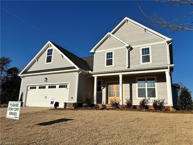 view of front of house featuring a porch, concrete driveway, and an attached garage