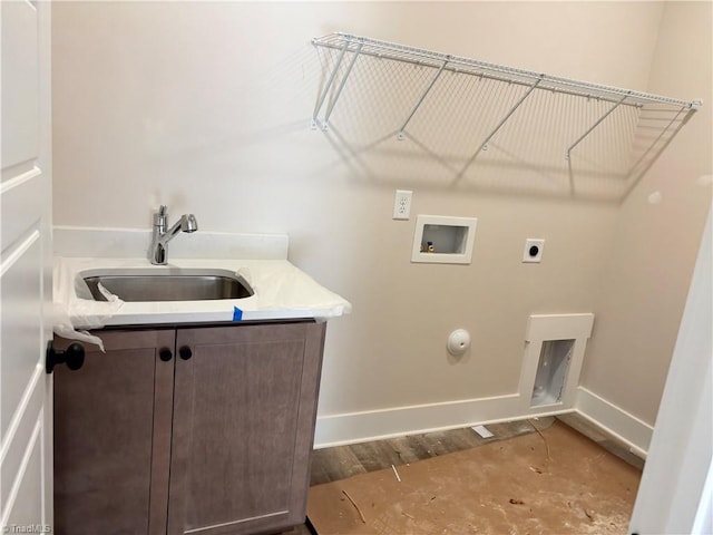 laundry room with baseboards, hookup for an electric dryer, cabinet space, a sink, and washer hookup