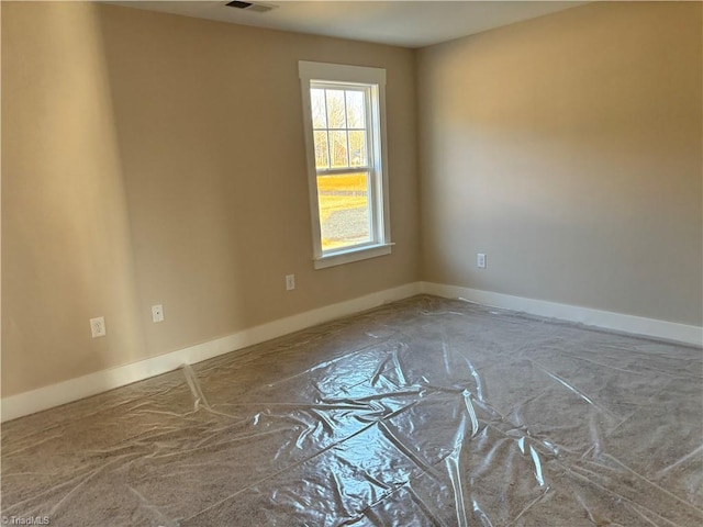 unfurnished room featuring visible vents and baseboards