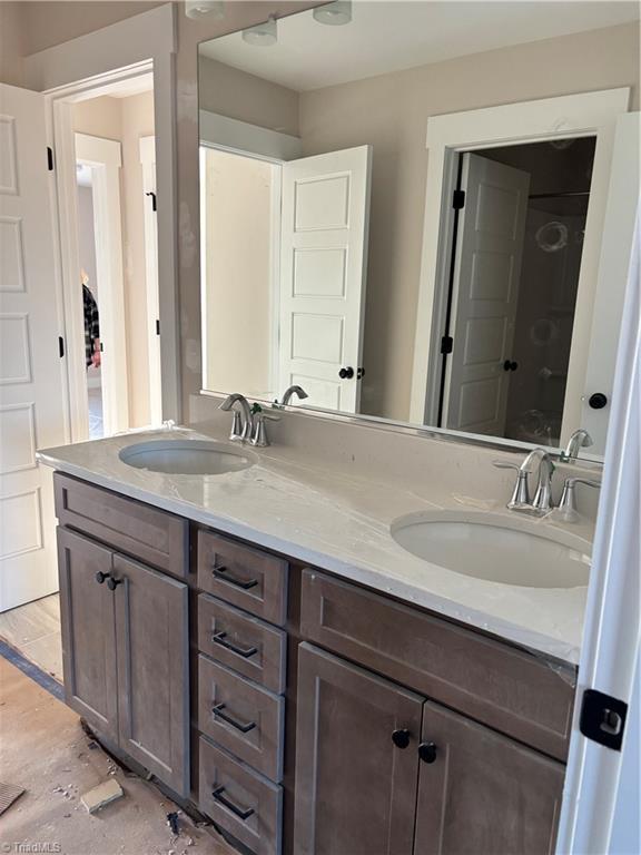 full bath with a sink and double vanity