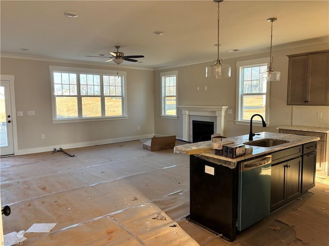 kitchen featuring a sink, stainless steel dishwasher, open floor plan, crown molding, and baseboards