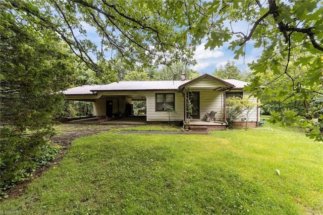 131 J Nettie Dr, Lexington, NC 27292 - rear view of property featuring a lawn, a carport, a metal roof, a chimney, and a porch