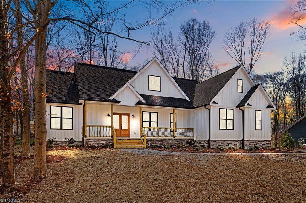 modern farmhouse with covered porch and french doors