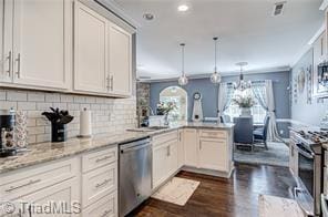 3855 Rutherford Ct, Winston-Salem, NC 27106 - kitchen with appliances with stainless steel finishes, a peninsula, dark wood-style floors, tasteful backsplash, and a sink