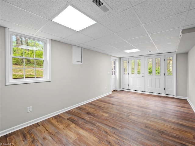 spare room featuring baseboards, visible vents, and wood finished floors