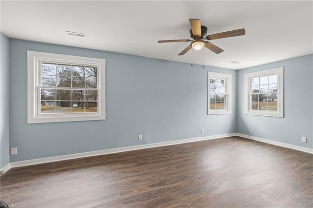 unfurnished room with ceiling fan and dark wood-type flooring