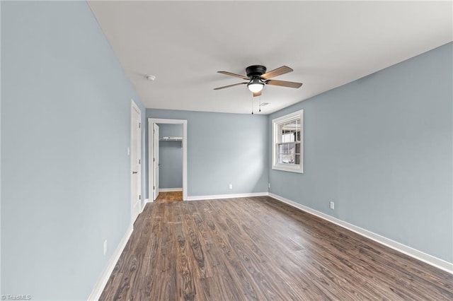 interior space with ceiling fan and dark hardwood / wood-style flooring