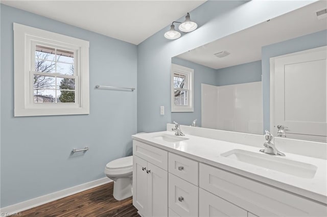 bathroom with hardwood / wood-style floors, vanity, and toilet