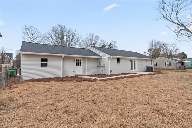 back of house with a lawn, central AC unit, and a patio area