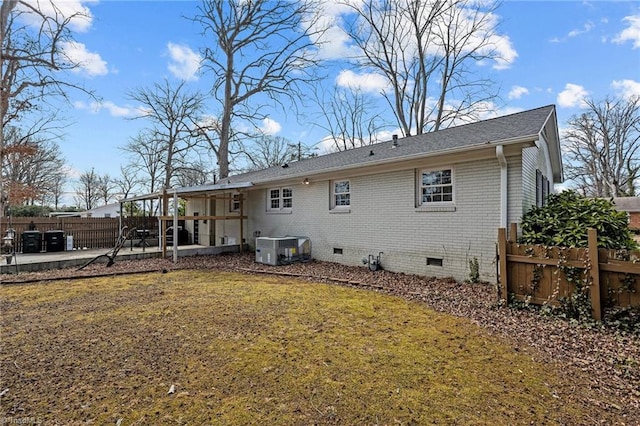 back of property featuring a lawn, a patio, and central air condition unit