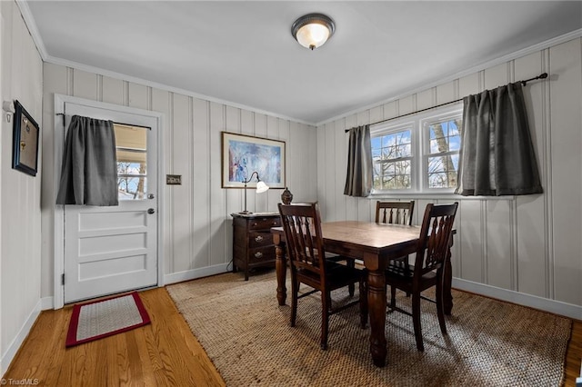 dining area featuring hardwood / wood-style flooring and ornamental molding