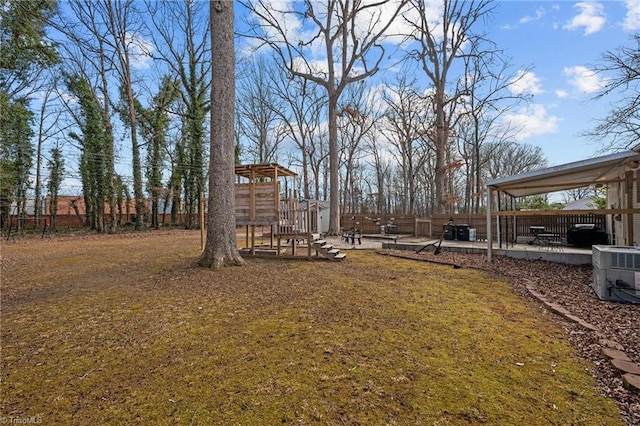 view of yard featuring a playground and central AC