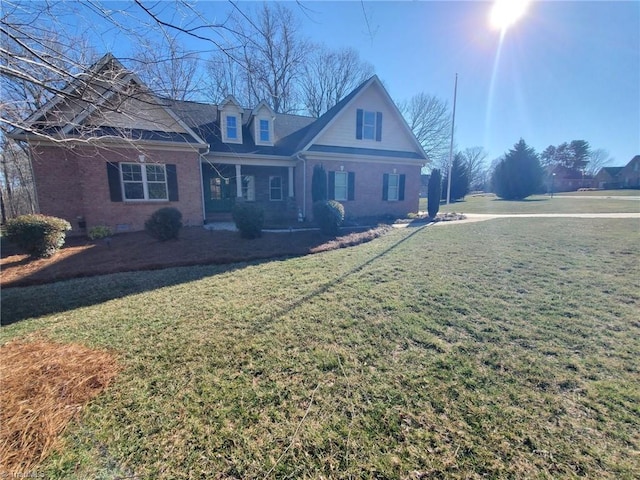 view of front of property with brick siding, crawl space, and a front yard