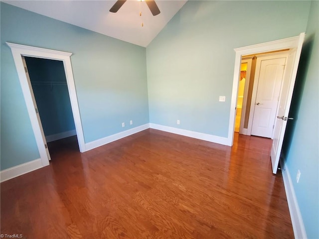 unfurnished bedroom featuring ceiling fan, wood finished floors, baseboards, vaulted ceiling, and a closet