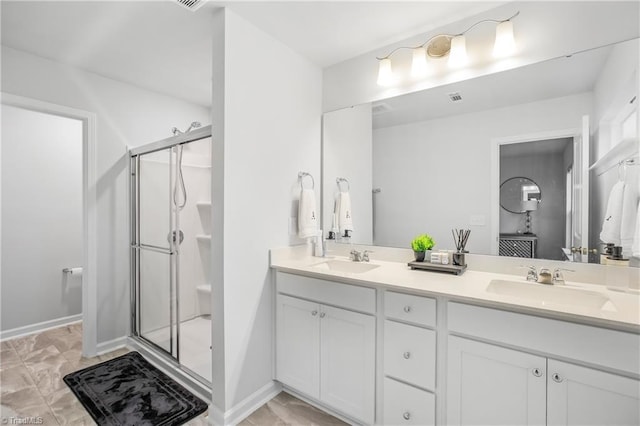 bathroom featuring vanity and a shower with shower door