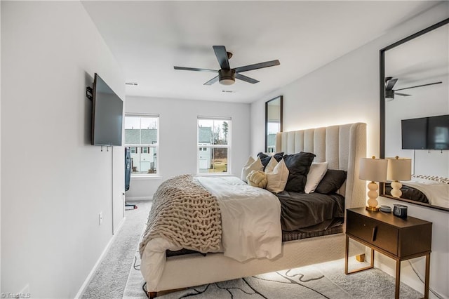 bedroom featuring ceiling fan and light carpet