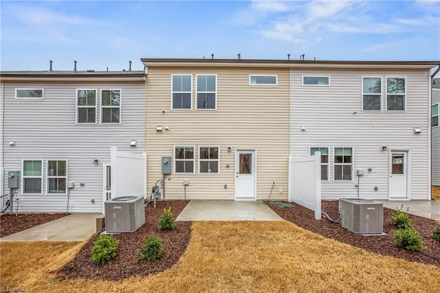 back of house featuring a lawn, cooling unit, and a patio area