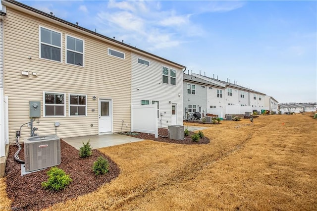 rear view of property featuring central AC, a patio area, and a yard