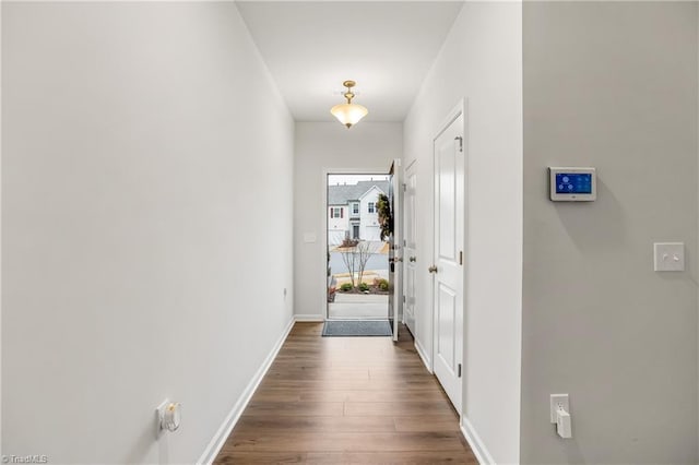 corridor with dark hardwood / wood-style floors