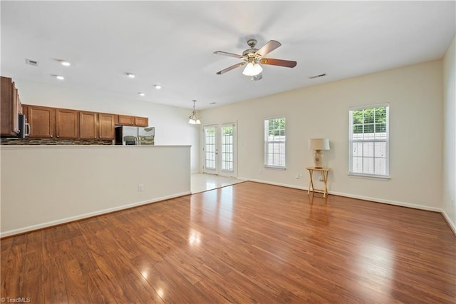 825 Central Park Ave, Greensboro, NC 27407 - unfurnished living room featuring plenty of natural light, wood finished floors, ceiling fan, baseboards, and recessed lighting