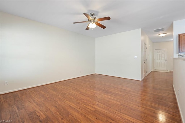 825 Central Park Ave, Greensboro, NC 27407 - spare room featuring wood finished floors, ceiling fan, and baseboards
