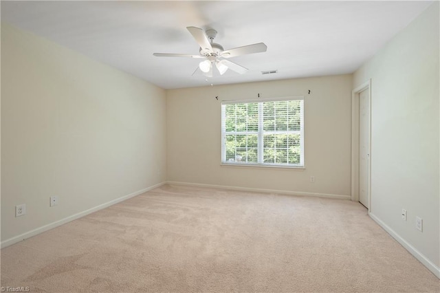 825 Central Park Ave, Greensboro, NC 27407 - spare room featuring light carpet, ceiling fan, and baseboards