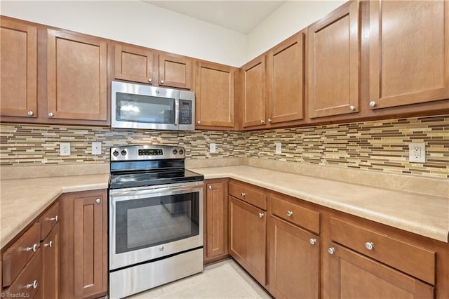 825 Central Park Ave, Greensboro, NC 27407 - kitchen with stainless steel appliances, light countertops, and backsplash