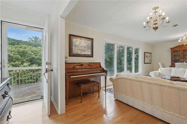 174 Sunny Knoll Ln, Boone, NC 28607 - living area with a chandelier, plenty of natural light, crown molding, and light wood-type flooring