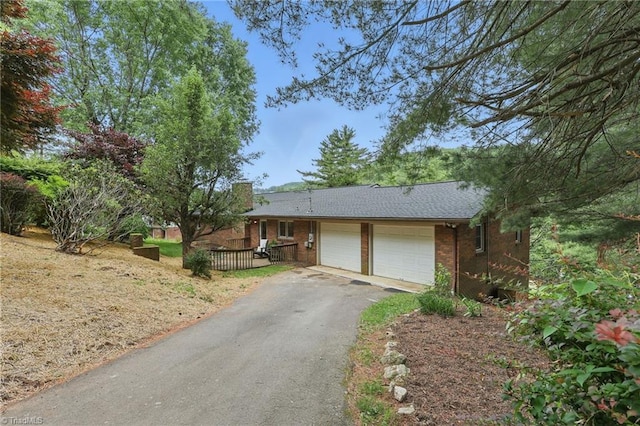 174 Sunny Knoll Ln, Boone, NC 28607 - single story home with an attached garage, asphalt driveway, and brick siding