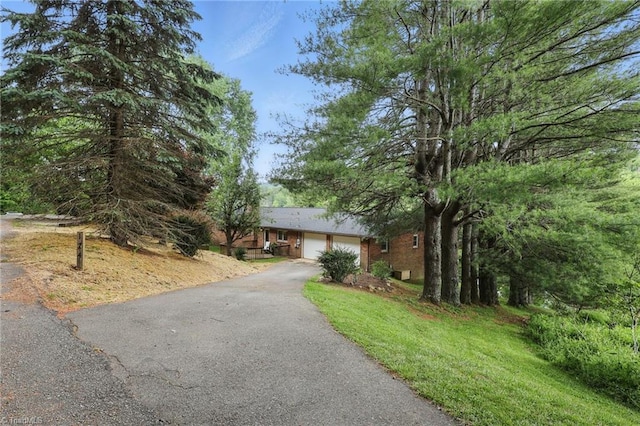 174 Sunny Knoll Ln, Boone, NC 28607 - ranch-style house featuring asphalt driveway and a garage