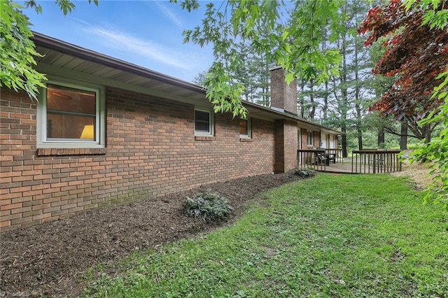 174 Sunny Knoll Ln, Boone, NC 28607 - view of side of home featuring a chimney, a yard, brick siding, and a wooden deck