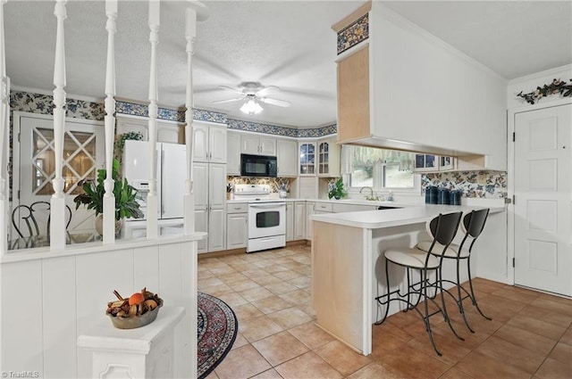 174 Sunny Knoll Ln, Boone, NC 28607 - kitchen featuring white appliances, a peninsula, ornamental molding, backsplash, and a ceiling fan