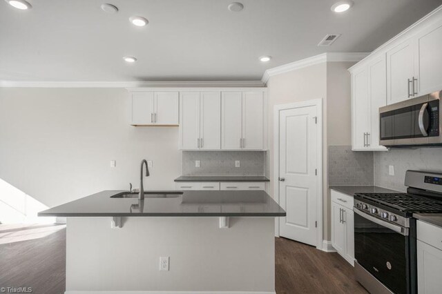 1404 Amberview Ln, Kernersville, NC 27284 - kitchen featuring crown molding, dark countertops, appliances with stainless steel finishes, and a sink
