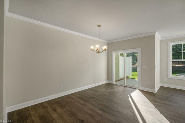 1404 Amberview Ln, Kernersville, NC 27284 - unfurnished dining area featuring plenty of natural light, a chandelier, dark wood-type flooring, and ornamental molding