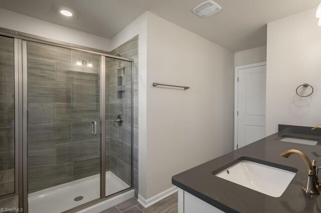 1404 Amberview Ln, Kernersville, NC 27284 - bathroom featuring baseboards, a sink, a shower stall, and double vanity