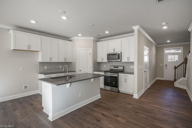 1404 Amberview Ln, Kernersville, NC 27284 - kitchen featuring crown molding, dark countertops, stainless steel appliances, and a sink