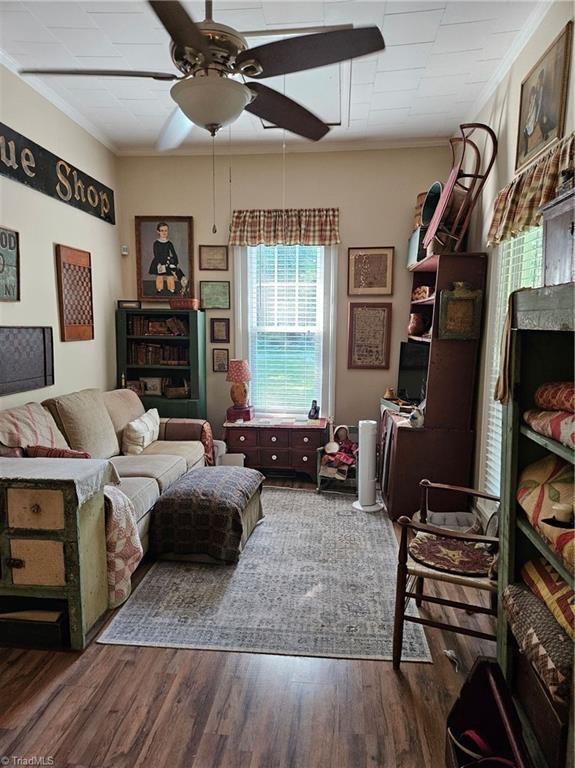 215 9th St, Spencer, NC 28159 - living room with ceiling fan, crown molding, and dark wood-style floors