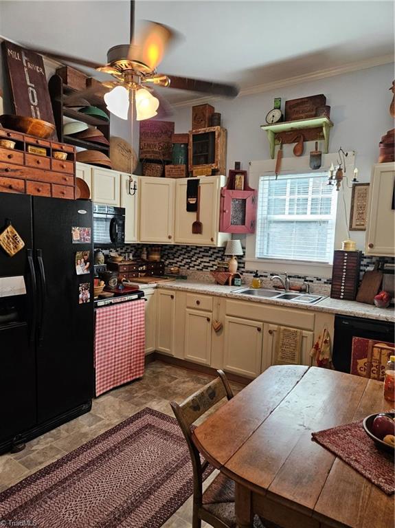 215 9th St, Spencer, NC 28159 - kitchen featuring black refrigerator with ice dispenser, decorative backsplash, a ceiling fan, ornamental molding, and light countertops