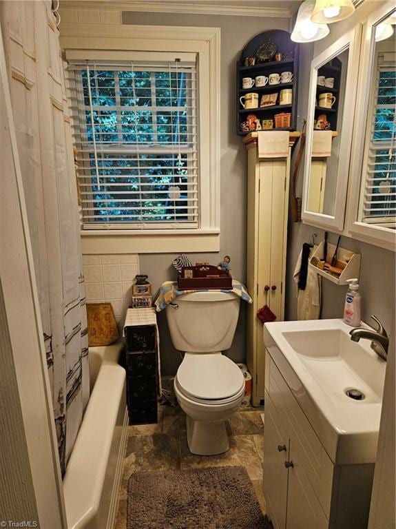 215 9th St, Spencer, NC 28159 - bathroom featuring vanity, ornamental molding, stone finish floors, and shower / tub combo