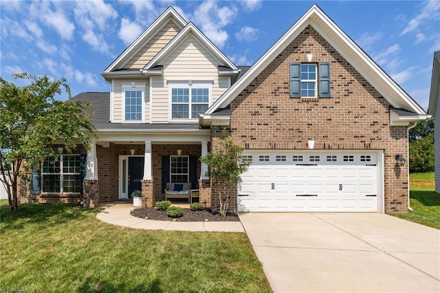 craftsman-style home featuring covered porch, a garage, and a front lawn